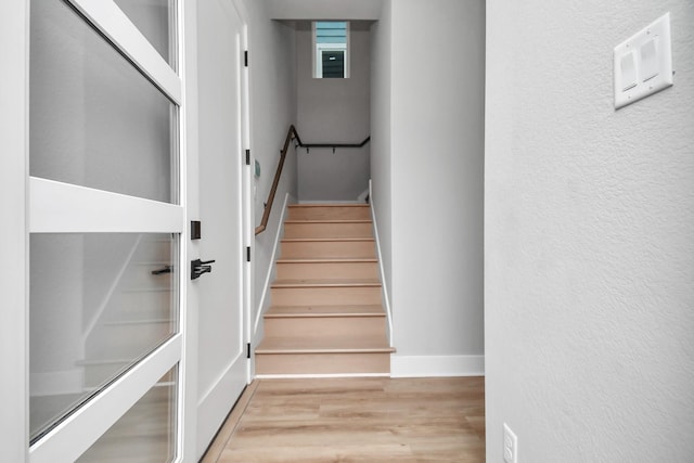 6817 Peerless St, Houston, TX 77021 - stairway with wood finished floors, a textured wall, and baseboards