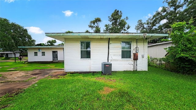 102 Jasmine St, Lake Jackson, TX 77566 - back of property featuring central AC unit and a yard