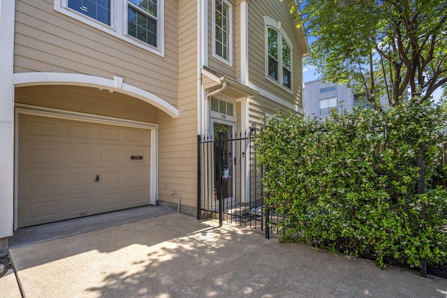 2703 Jackson St, Houston, TX 77004 - view of exterior entry with an attached garage, concrete driveway, and a gate