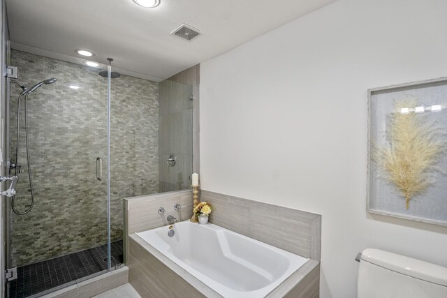 2703 Jackson St, Houston, TX 77004 - bathroom featuring a bath, a stall shower, toilet, and recessed lighting