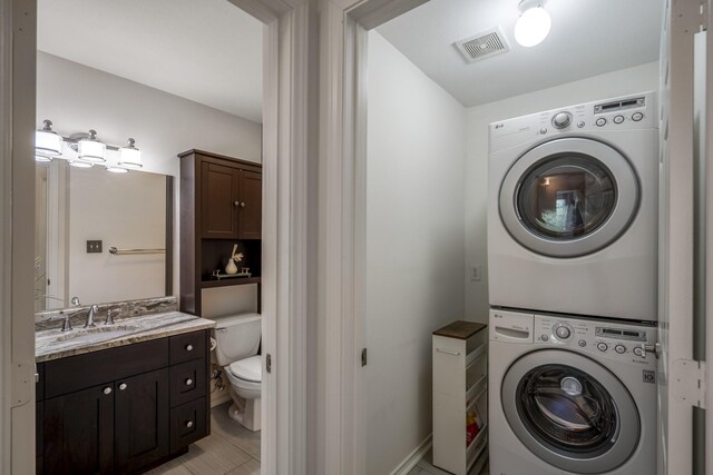 2703 Jackson St, Houston, TX 77004 - laundry room with estacked washer and dryer and baseboards