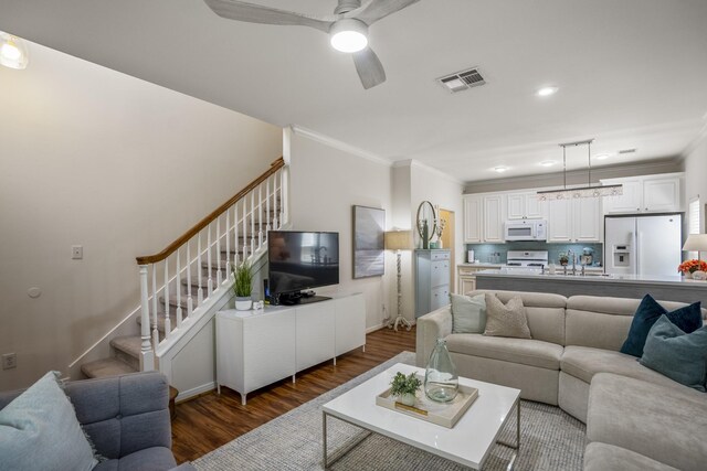 2703 Jackson St, Houston, TX 77004 - living room with crown molding, wood finished floors, stairs, a ceiling fan, and recessed lighting