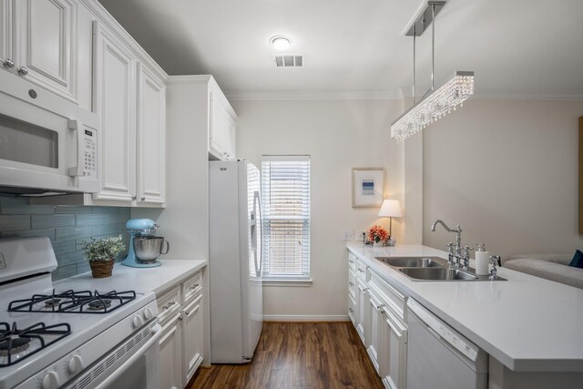 2703 Jackson St, Houston, TX 77004 - kitchen featuring white appliances, a sink, a peninsula, crown molding, and dark wood-type flooring