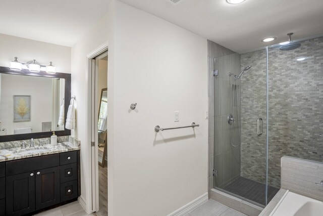 2703 Jackson St, Houston, TX 77004 - bathroom featuring a shower stall, tile patterned flooring, baseboards, vanity, and a tub