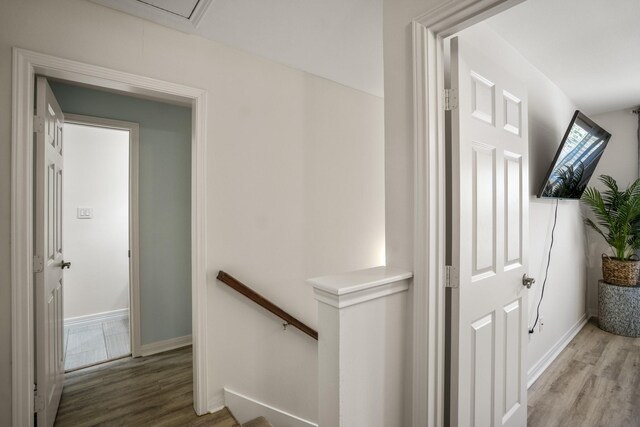 2703 Jackson St, Houston, TX 77004 - hallway with an upstairs landing, wood finished floors, and baseboards