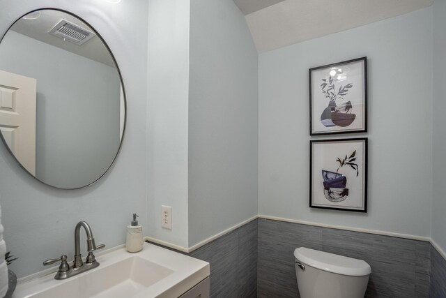 2703 Jackson St, Houston, TX 77004 - bathroom featuring toilet, tile walls, wainscoting, and vanity
