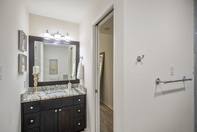 2703 Jackson St, Houston, TX 77004 - bathroom featuring vanity, wood finished floors, and baseboards