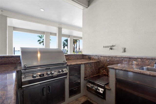 7123 Broadway St, Galveston, TX 77554 - kitchen with a sink and dark brown cabinetry