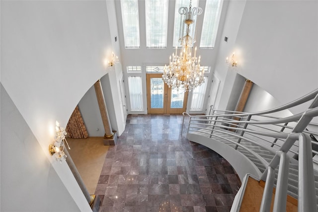7123 Broadway St, Galveston, TX 77554 - entrance foyer featuring a chandelier, french doors, a towering ceiling, stairs, and arched walkways