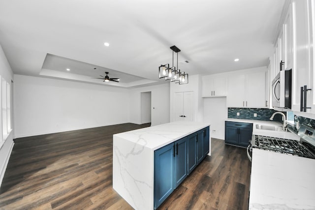 7430 Avenue E Ave E, Beasley, TX 77417 - kitchen with appliances with stainless steel finishes, blue cabinetry, ceiling fan, white cabinets, and recessed lighting