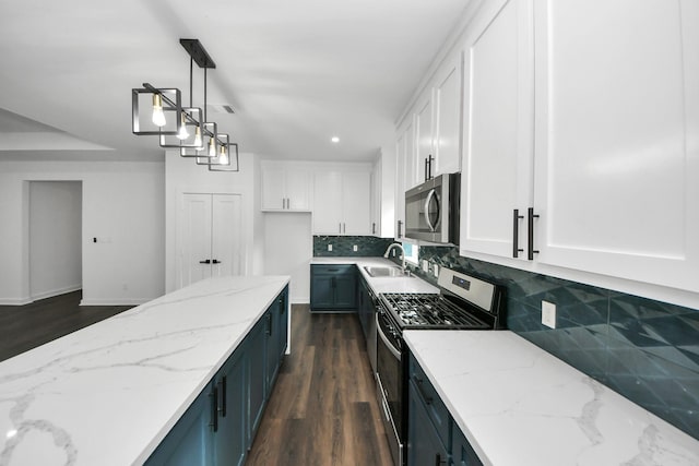 7430 Avenue E Ave E, Beasley, TX 77417 - kitchen with appliances with stainless steel finishes, white cabinetry, a sink, decorative backsplash, and recessed lighting