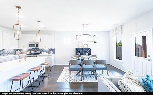 418 Riesling Dr, Alvin, TX 77511 - dining space with dark wood finished floors, a chandelier, and baseboards