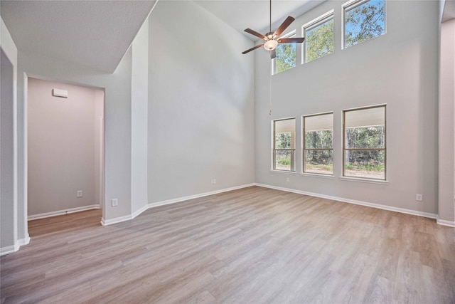 1497 Rd 66114, Dayton, TX 77535 - unfurnished living room with a ceiling fan, wood finished floors, and high vaulted ceiling