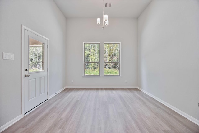 1497 Rd 66114, Dayton, TX 77535 - unfurnished dining area featuring healthy amount of natural light, wood finished floors, and a chandelier