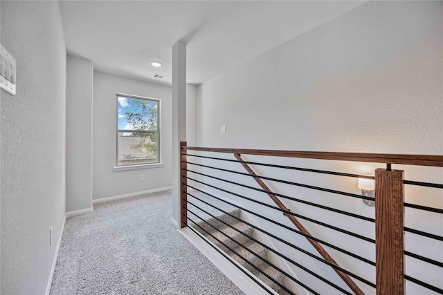1497 Rd 66114, Dayton, TX 77535 - hall with an upstairs landing, carpet floors, and a textured wall
