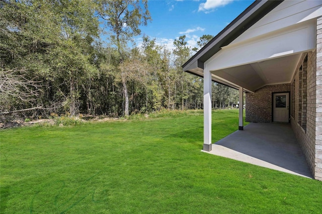 1497 Rd 66114, Dayton, TX 77535 - view of grassy yard featuring a patio area