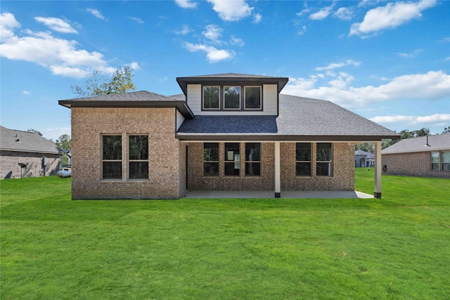 1497 Rd 66114, Dayton, TX 77535 - rear view of house with a patio, brick siding, a yard, and a shingled roof