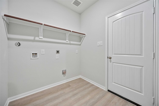 1497 Rd 66114, Dayton, TX 77535 - washroom featuring light wood-type flooring, hookup for an electric dryer, hookup for a washing machine, and gas dryer hookup