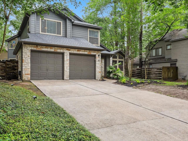 10 Leaf Trace Ct, The Woodlands, TX 77381 - view of front facade with stone siding, driveway, and a shingled roof
