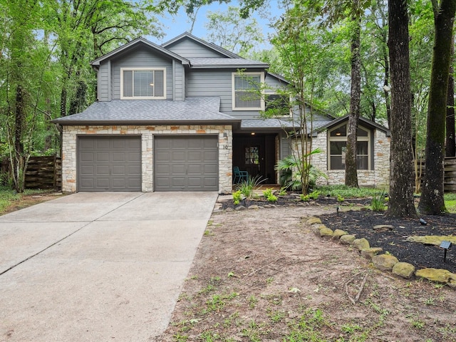 10 Leaf Trace Ct, The Woodlands, TX 77381 - view of front of home featuring stone siding, an attached garage, driveway, and a shingled roof