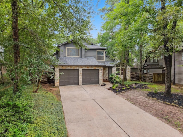 10 Leaf Trace Ct, The Woodlands, TX 77381 - view of front facade with driveway, an attached garage, and a shingled roof