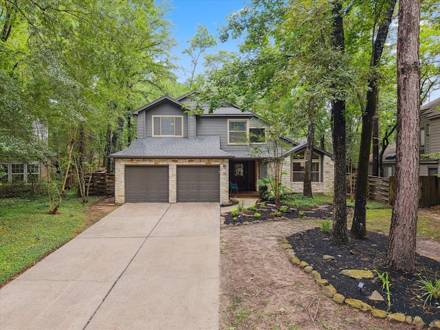10 Leaf Trace Ct, The Woodlands, TX 77381 - view of front of home featuring a garage, driveway, stone siding, and roof with shingles