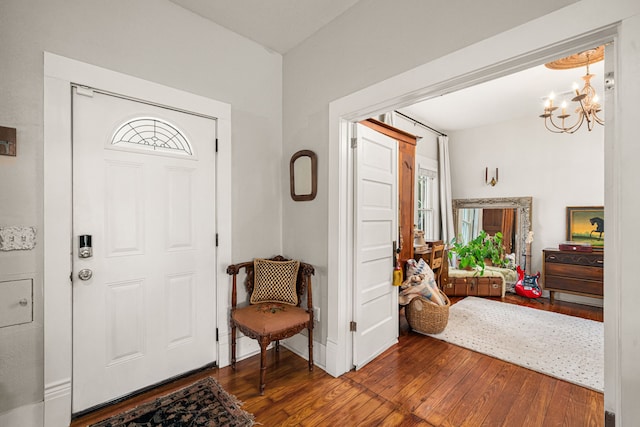 1039 Louise St, Houston, TX 77009 - foyer with wood-type flooring, a chandelier, healthy amount of natural light, and baseboards