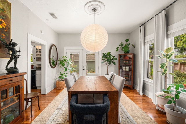 1039 Louise St, Houston, TX 77009 - dining area featuring french doors, wood finished floors, and baseboards