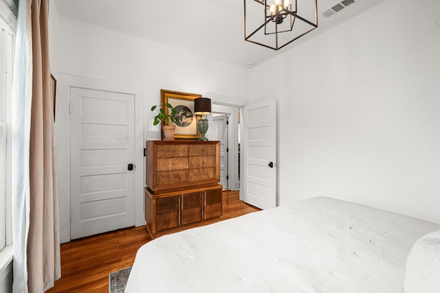 1039 Louise St, Houston, TX 77009 - bedroom with wood finished floors and a chandelier