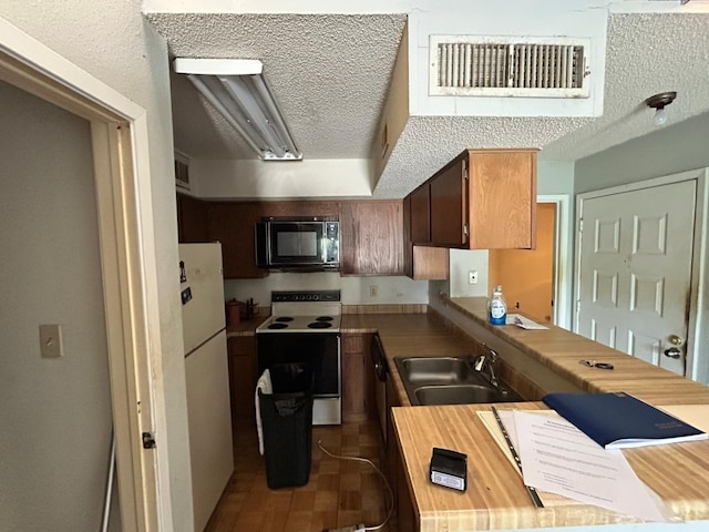 10855 Meadowglen Ln Unit 723, Houston, TX 77042 - kitchen with white appliances, a sink, and light countertops