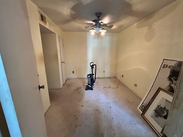 10855 Meadowglen Ln Unit 723, Houston, TX 77042 - empty room with ceiling fan, a textured ceiling, and baseboards