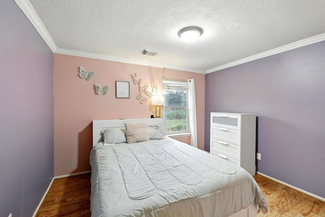 3002 Trinity Pass Ct, Spring, TX 77373 - bedroom with a textured ceiling, ornamental molding, and wood finished floors