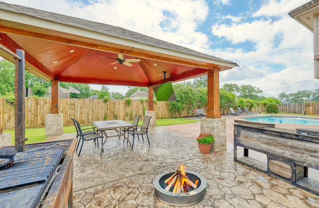 3002 Trinity Pass Ct, Spring, TX 77373 - fenced backyard featuring a gazebo, an outdoor fire pit, ceiling fan, outdoor dining area, and a patio