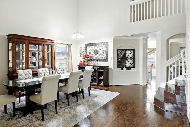 3002 Trinity Pass Ct, Spring, TX 77373 - dining area featuring a chandelier, a high ceiling, stairs, wood finished floors, and arched walkways