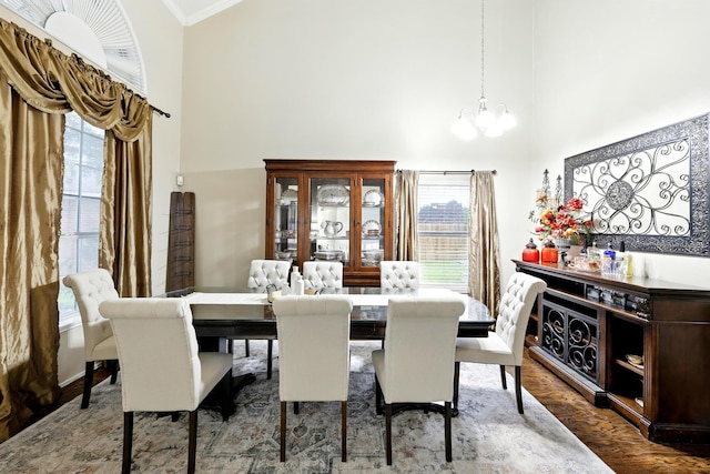 3002 Trinity Pass Ct, Spring, TX 77373 - dining space with a chandelier, a high ceiling, plenty of natural light, wood finished floors, and ornamental molding