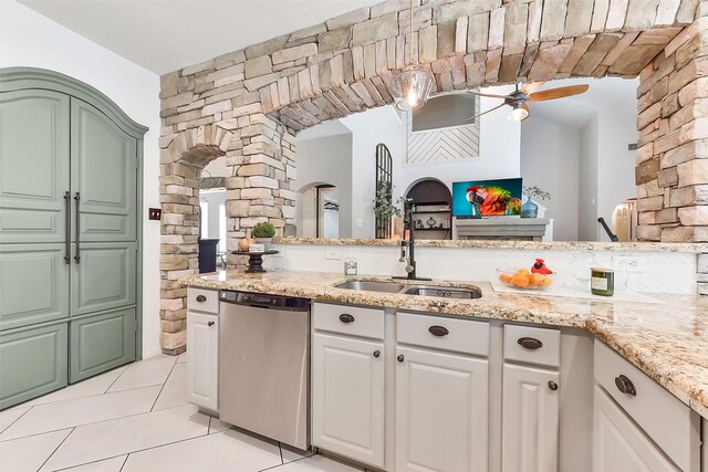 14222 Autumn Mist, Cypress, TX 77429 - kitchen featuring stainless steel dishwasher, light tile patterned floors, ceiling fan, a sink, and light stone counters