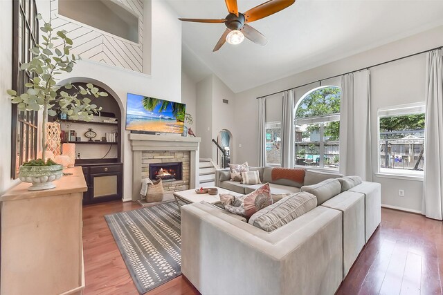 14222 Autumn Mist, Cypress, TX 77429 - living room with high vaulted ceiling, wood finished floors, a stone fireplace, and ceiling fan
