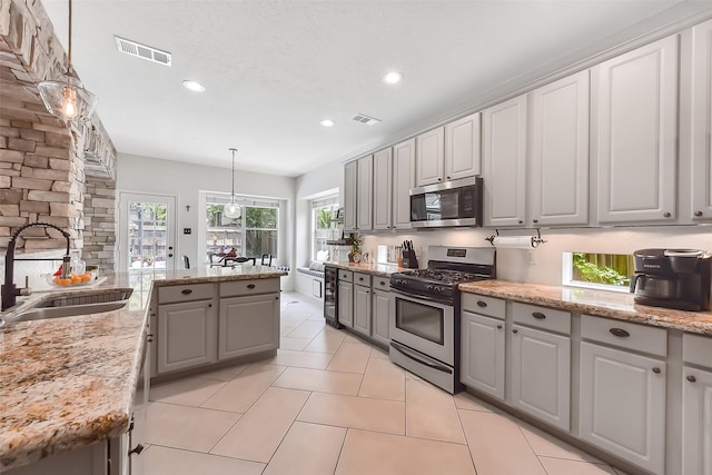 14222 Autumn Mist, Cypress, TX 77429 - kitchen featuring appliances with stainless steel finishes, a sink, gray cabinets, recessed lighting, and pendant lighting