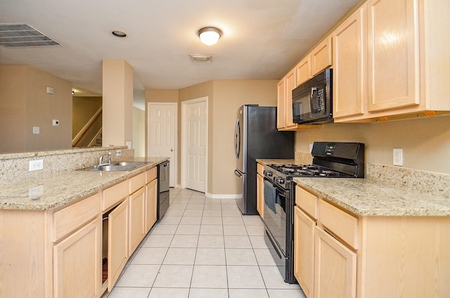 7811 Holly Berry Ct, Cypress, TX 77433 - kitchen featuring black appliances, a sink, light brown cabinets, light tile patterned floors, and light stone counters