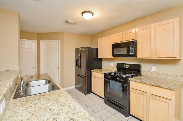 7811 Holly Berry Ct, Cypress, TX 77433 - kitchen featuring black appliances, a sink, light brown cabinets, light countertops, and light tile patterned flooring