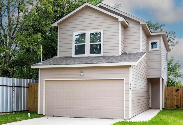5801 Phillips St, Houston, TX 77091 - view of front facade with a shingled roof, an attached garage, and concrete driveway