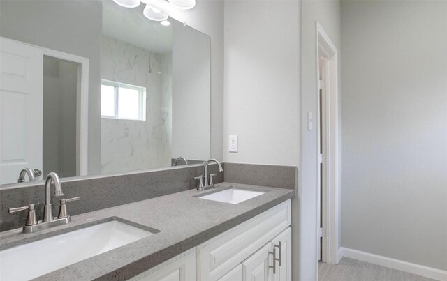 5801 Phillips St, Houston, TX 77091 - full bathroom featuring double vanity and baseboards