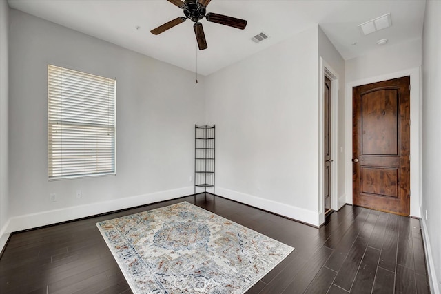 2010 Sabine St, Houston, TX 77007 - unfurnished room featuring baseboards, dark wood-style flooring, and ceiling fan