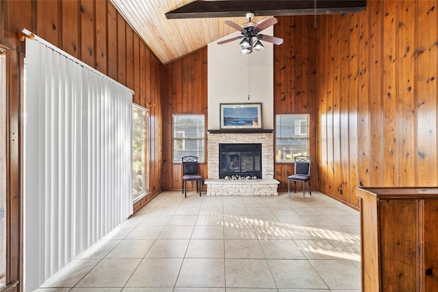 7 Lake Dr, Huntsville, TX 77320 - living room featuring high vaulted ceiling, wooden walls, light tile patterned floors, wood ceiling with exposed beams, and a fireplace