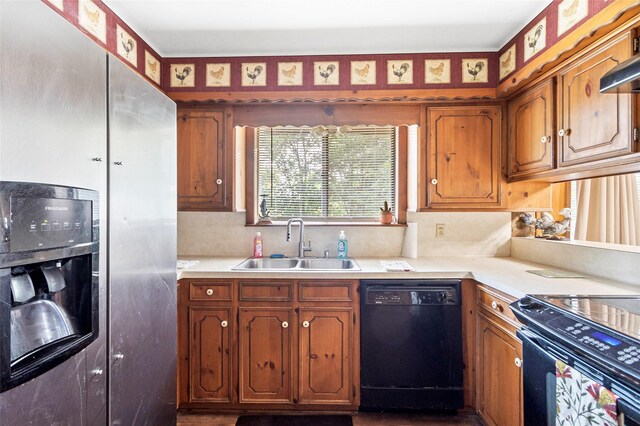 7 Lake Dr, Huntsville, TX 77320 - kitchen with black appliances, a sink, light countertops, brown cabinetry, and tasteful backsplash