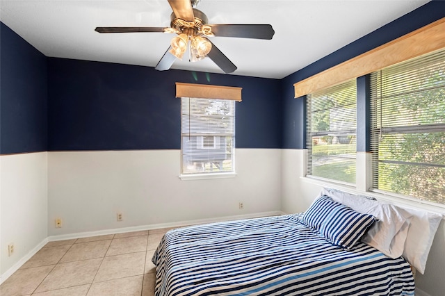 7 Lake Dr, Huntsville, TX 77320 - tiled bedroom with ceiling fan and baseboards