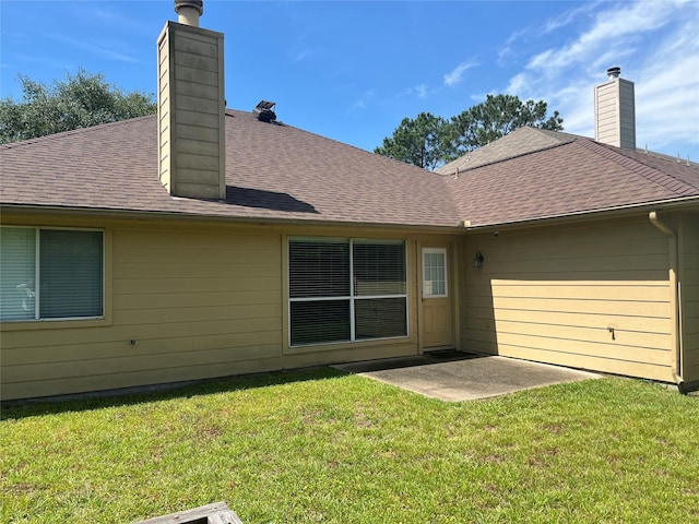10406 Friars Hill Ln, Houston, TX 77070 - rear view of property featuring a chimney, a lawn, roof with shingles, and a patio