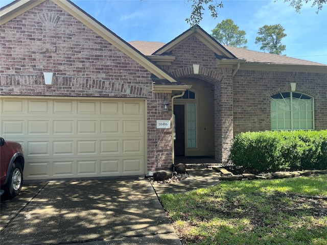 10406 Friars Hill Ln, Houston, TX 77070 - view of front of home with driveway, brick siding, a garage, and a shingled roof