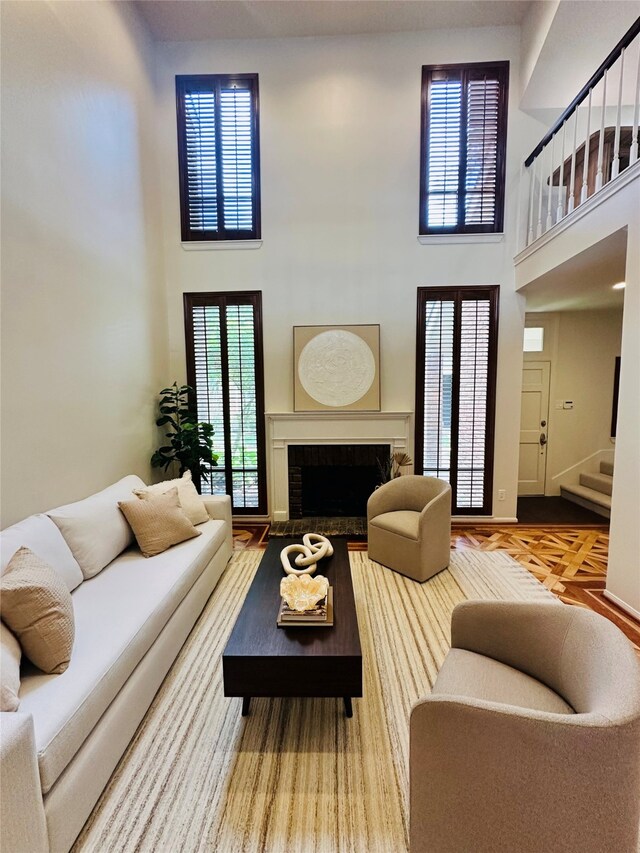2901 Bammel Ln Unit 17, Houston, TX 77098 - living area featuring a towering ceiling, stairs, and a brick fireplace
