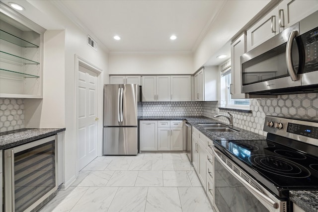2901 Bammel Ln Unit 17, Houston, TX 77098 - kitchen featuring appliances with stainless steel finishes, wine cooler, a sink, ornamental molding, and dark stone countertops
